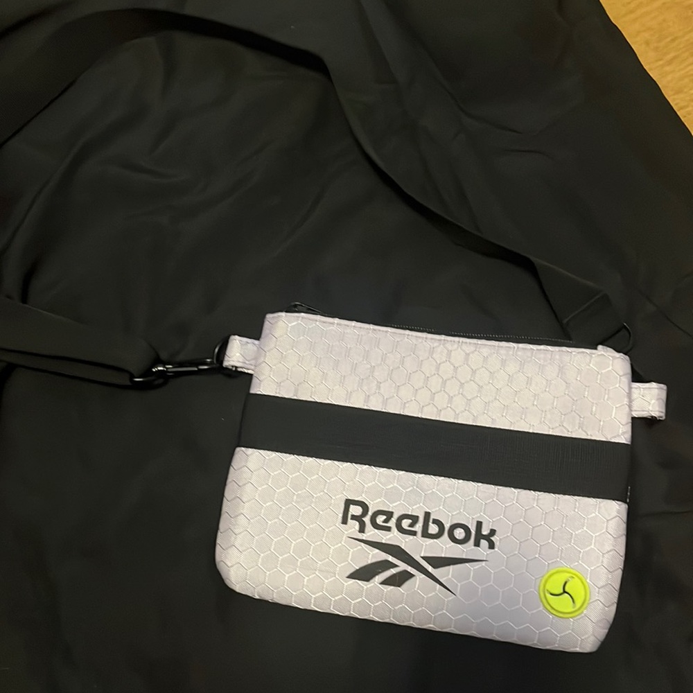 Reebok crossbody ouch with hole for poop bags used for dog walking